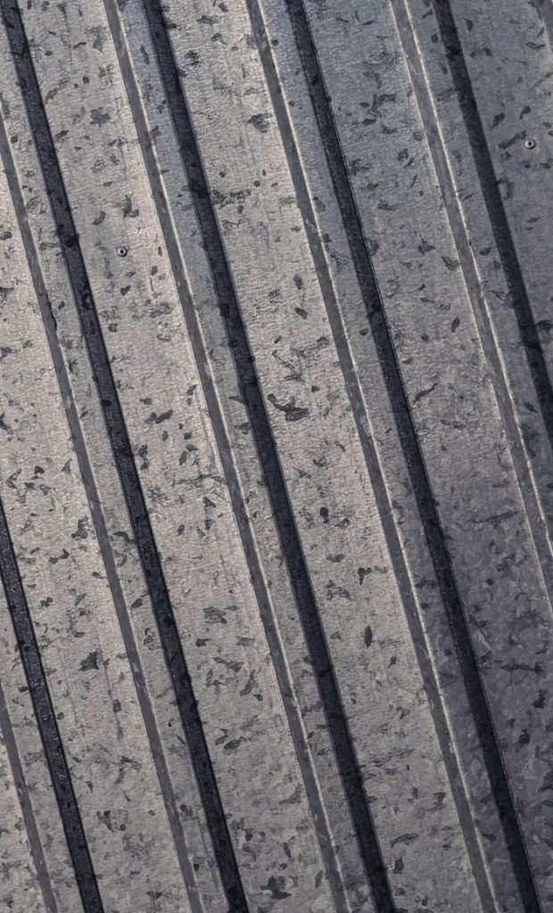 Close-up of vertical steel surface showcasing detailed texture and speckles.